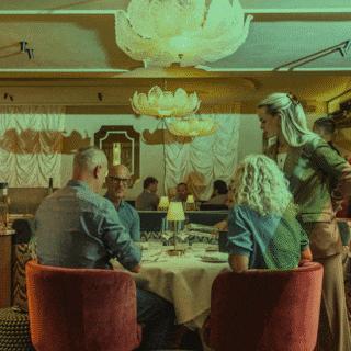Interior of Chez Chloé bistro in Amsterdam-West showing the custom wine cabinet that serves as the room's centrepiece