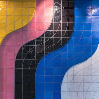 Tile mosaics with 'un-Dutch sunniness' compensate for the grey concrete of the VU building