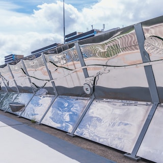Reflective artwork on Erasmusgracht bridge hides noise barriers and connects neighborhoods