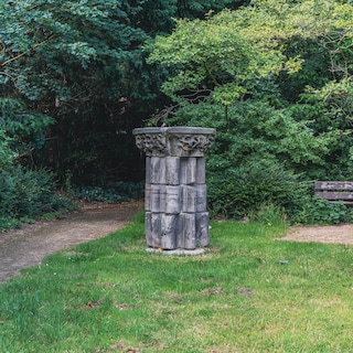 This artwork is a picturesque world with medieval columns, a romantic oasis among apartment buildings