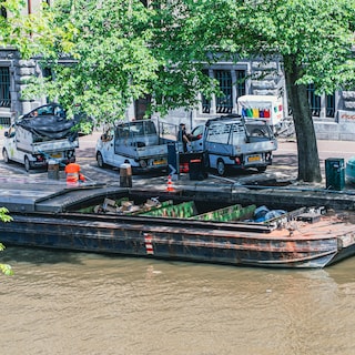 Residents push back against waste boat moored in the heart of Amsterdam: ‘All day you hear the constant clinking of glass – and that’s before we even get to the smell’