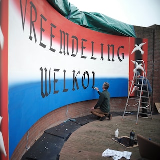 ‘Strangers welcome’ appears on the Haringpakkersbrug near Amsterdam Central: ‘A warm gesture in a very sinister guise’