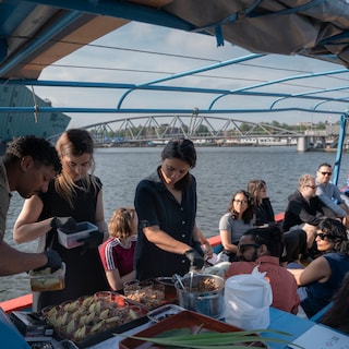 Breakfast snacks and singing on a former refugee boat on the canals: ‘Art is an opportunity to start a conversation’